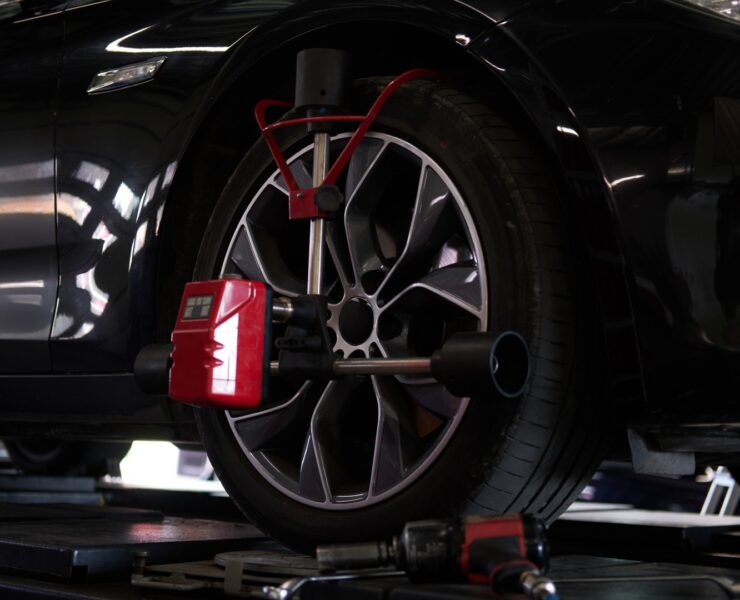 Closeup photoshoot of process or tyre balancing at dark auto service.